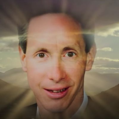 Warren Jeffs face is shown is some kind of light coming from him.